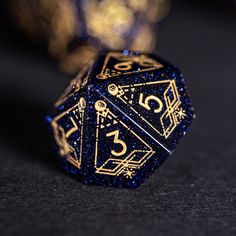 a blue and gold dice sitting on top of a table