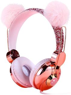 the headphones are pink and gold with fuzzy pom - poms on them