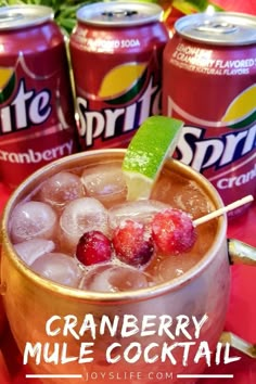 cranberry mule cocktail in a copper mug with strawberries and lime garnish