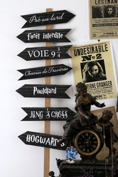 there are many signs on the wall that point to different places in the world, including harry potter