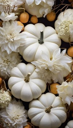 white pumpkins and flowers are arranged together