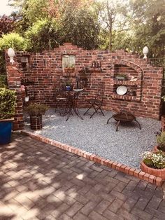 an outdoor patio with brick walls and gravel