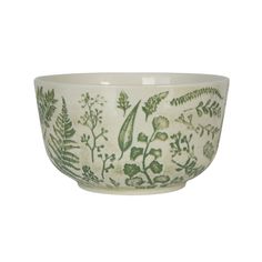 a green and white bowl with plants on it