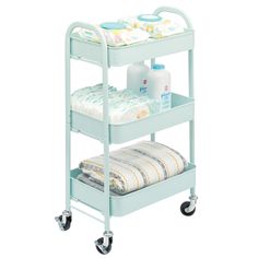 a baby changing table on wheels with diapers and wipes in the bottom shelf