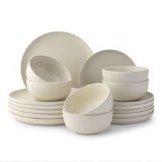 a stack of white dishes sitting on top of each other