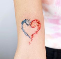 a woman's arm with a heart shaped tattoo on the side of her body