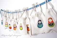 several bags with different designs hanging from a line