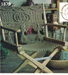 a wooden chair sitting on top of a floor next to a basket filled with yarn