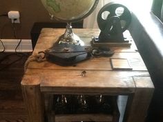 an antique globe sits on top of a wooden table