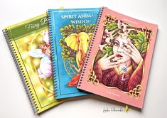 three spiral notebooks with pictures of angels and the words spirit animal wisdon on them