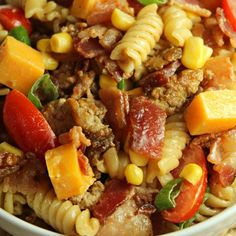 a white bowl filled with pasta and vegetables