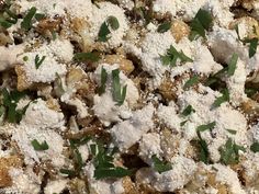 a close up view of some food that is covered in powdered sugar and herbs