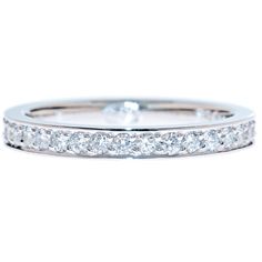 a white gold wedding ring with diamonds on the sides and an invisible channel in the middle