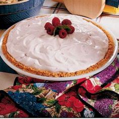 there is a pie on the table with strawberries on top