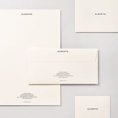 the stationery is laid out neatly on top of each other, including envelopes and business cards