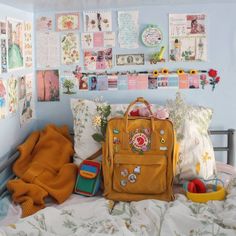 a yellow purse sitting on top of a bed covered in lots of pillows and blankets