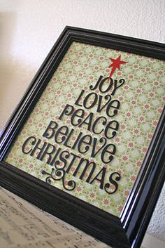 a framed christmas card with the words joy, love, peace and believe on it