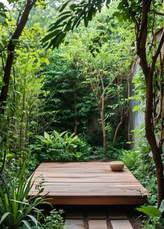 a wooden deck surrounded by greenery and trees