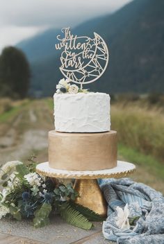 a wedding cake sitting on top of a wooden table