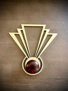 an art deco broochle on a wooden surface with geometric shapes in the center