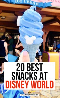 someone holding up a blue ice cream cone with the words 20 best snacks at disney world