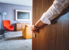 a person's hand on the door handle of a hotel room