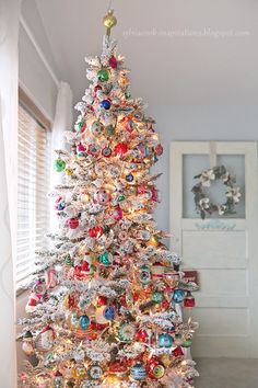 a white christmas tree with ornaments on it