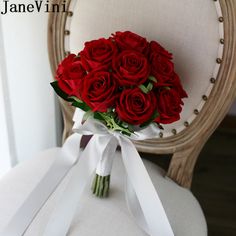 a bouquet of red roses sitting on top of a chair