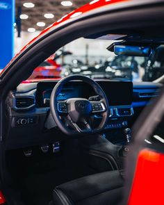 the interior of a red and black car