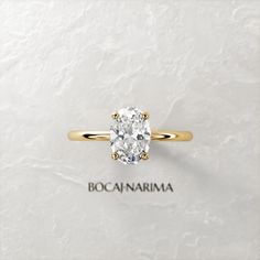 an oval diamond ring with the name boocannarma written on it in gold