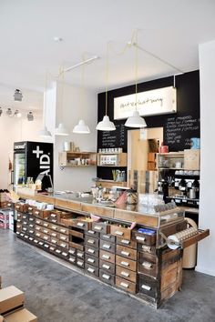 the inside of a coffee shop with lots of drawers