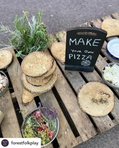 a wooden table topped with lots of different types of pizzas and other food items