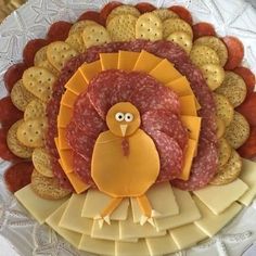 a turkey shaped platter with crackers and cheeses on the side for decoration