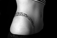 black and white photo of a woman's lower back tattoo