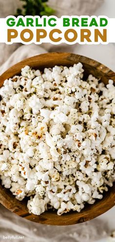 garlic bread popcorn in a wooden bowl with text overlay that reads garlic bread popcorn