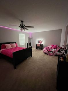 a bed room with a neatly made bed and pink comforter on top of it