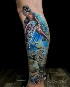 a man's leg with a turtle and fish tattoo on it