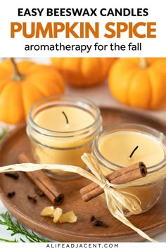 two jars filled with homemade pumpkin spice on top of a wooden tray next to cinnamon sticks and