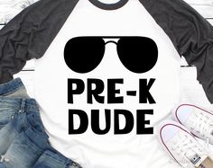 a t - shirt that says prek dude with sunglasses on it, next to jeans and sneakers