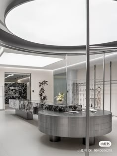 the interior of a modern office building with circular glass partitions and marble counter tops