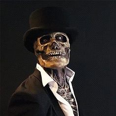 a skeleton dressed in a suit and top hat