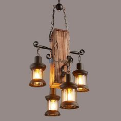 an old fashioned chandelier with five lights hanging from it's chain and attached to