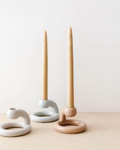 two candles sitting next to each other on top of a table