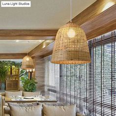 a living room filled with lots of furniture next to a window covered in bamboo blinds