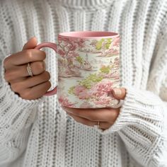 a woman holding a pink coffee mug in her hands