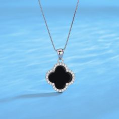 This exquisite necklace captures the essence of timeless charm, showcasing a black clover pendant adorned with meticulously placed cubic zirconia stones that add a touch of sparkle and elegance. Crafted with meticulous attention, it promises enduring brilliance and quality. The black clover motif, symbolizing fortune, combined with the shimmering pave contour, creates a versatile accessory that effortlessly enhances any look. Necklace length: 40+3cm;Pendant size 16*16mm;925 Sterling Silver;White Black Jewelry Necklace Flowers, Luxury Black Charms Jewelry, Luxury Black Necklace With Jewels, Customized Black Jewelry At Cheap Price, Cheap Customizable Black Jewelry, Cheap Classic Black Jewelry, Luxury Black Necklaces With Detachable Pendant, Luxury Black Necklace With Detachable Pendant, Luxury Black Stone Necklaces