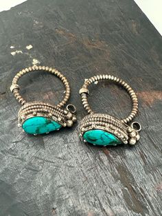 This exquisite earring is a stunning piece of traditional Tibetan jewelry handcrafted entirely by skilled artisans. This intricate design features turquoise set in Tibetan silver show casing the unique and beautiful culture of Tibet and Nepal Handmade Ceremonial Jewelry For Festivals, Artisan Pierced Pendant Jewelry, Traditional Handmade Metal Clip-on Earrings, Artisan Jewelry With Oxidized Finish For Festivals, Artisan Oxidized Finish Jewelry For Festivals, Artisan Metal Jewelry For Festive Occasions, Traditional Turquoise Jewelry For Gift, Festival Pendant Jewelry With Matching Earrings, Traditional Pendant Jewelry For Jewelry Making