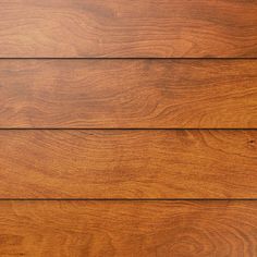 closeup of wood grained boards on a house's exterior wall, with the top part showing