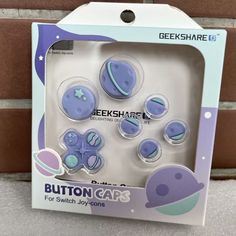 a package of buttons in the shape of an astronaut's space ship and planets