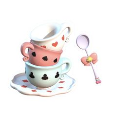 two cups with spoons are stacked on top of each other in the shape of hearts